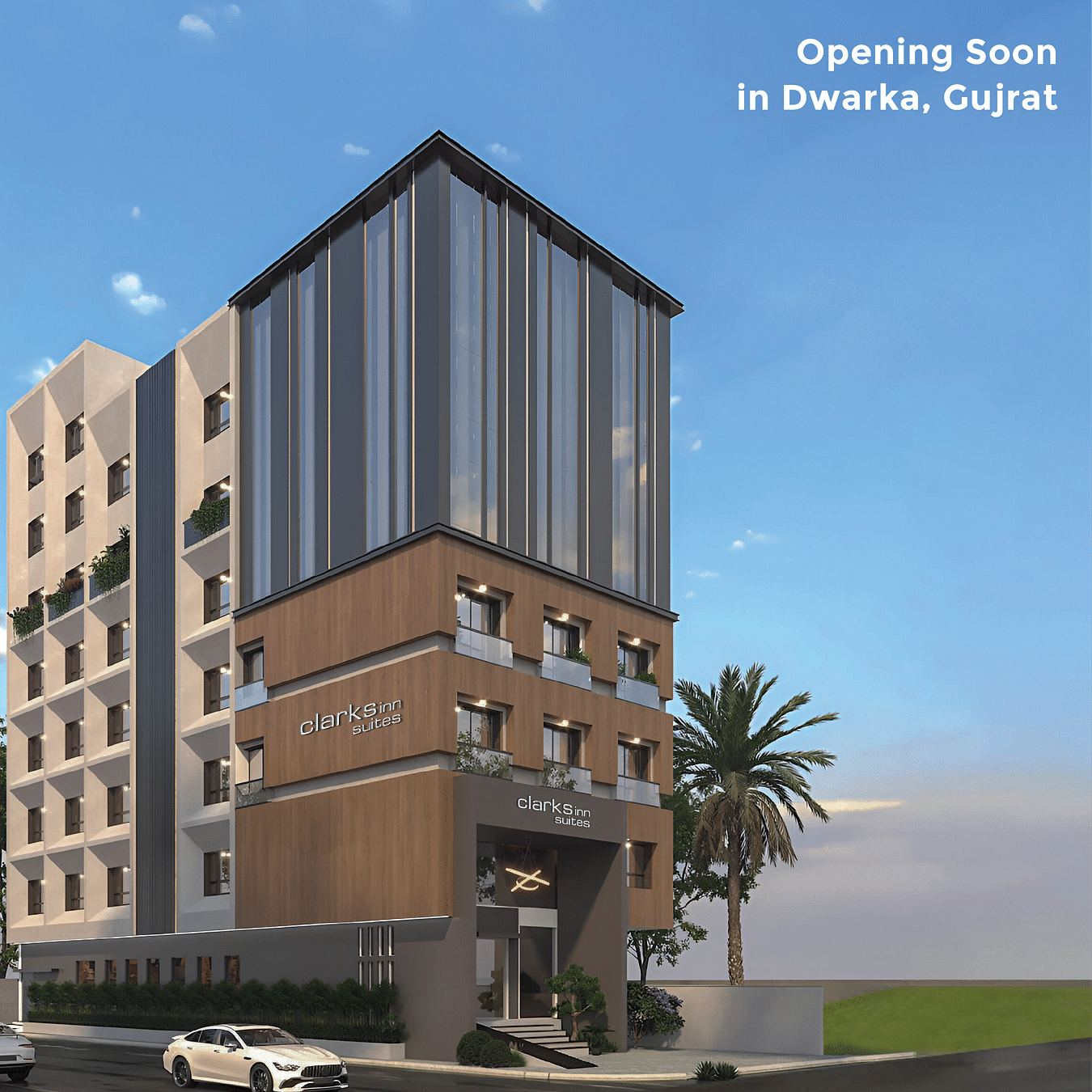 A modern Clarks Inn Suites hotel building stands under a blue sky with the hotel signage visible and text - Opening Soon in Dwarka, Gujrat.
