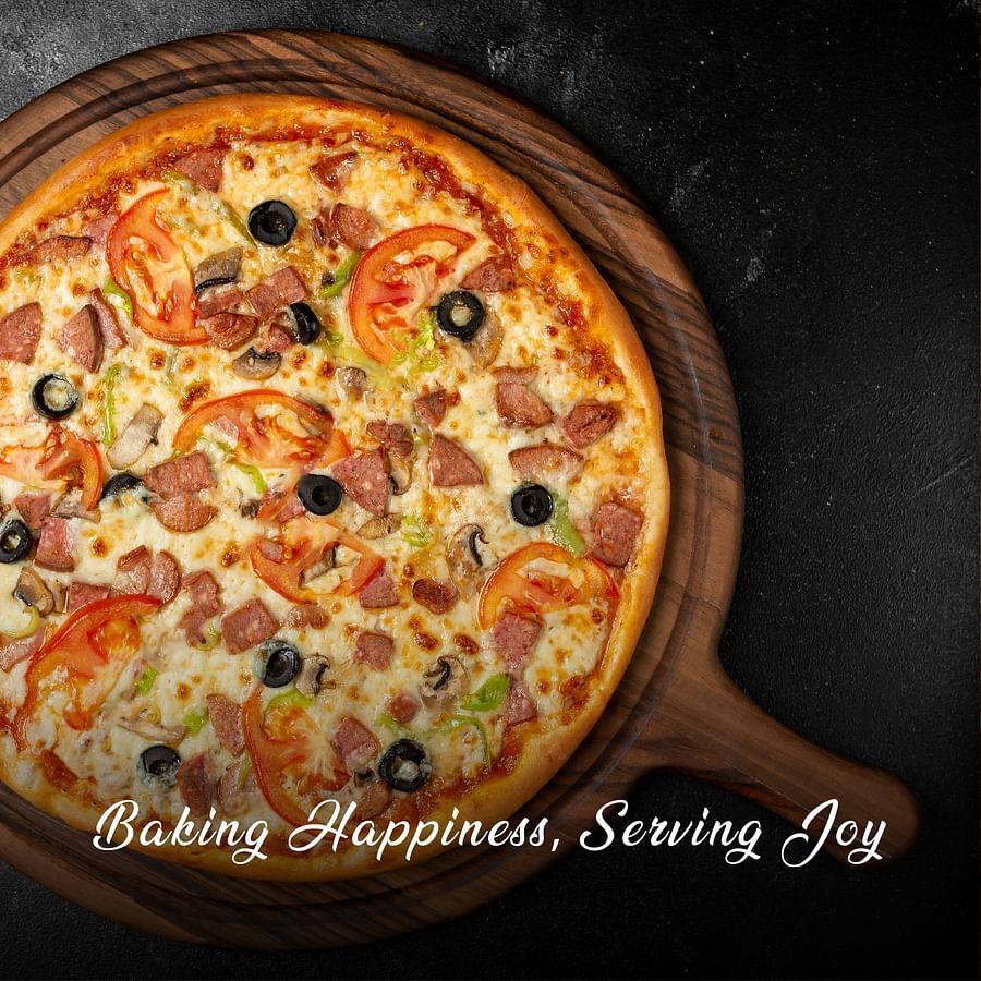 a pizza with a viariety of toppings - O by Tamara Trivandrum