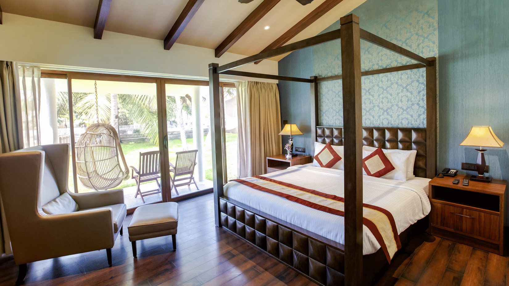 A suite with a double bed, sofa, and windows | MGM Hotels & Resorts