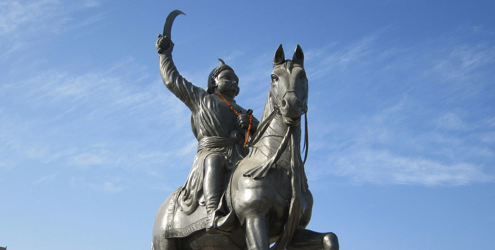 a statue of a fighter on a horse with a sword
