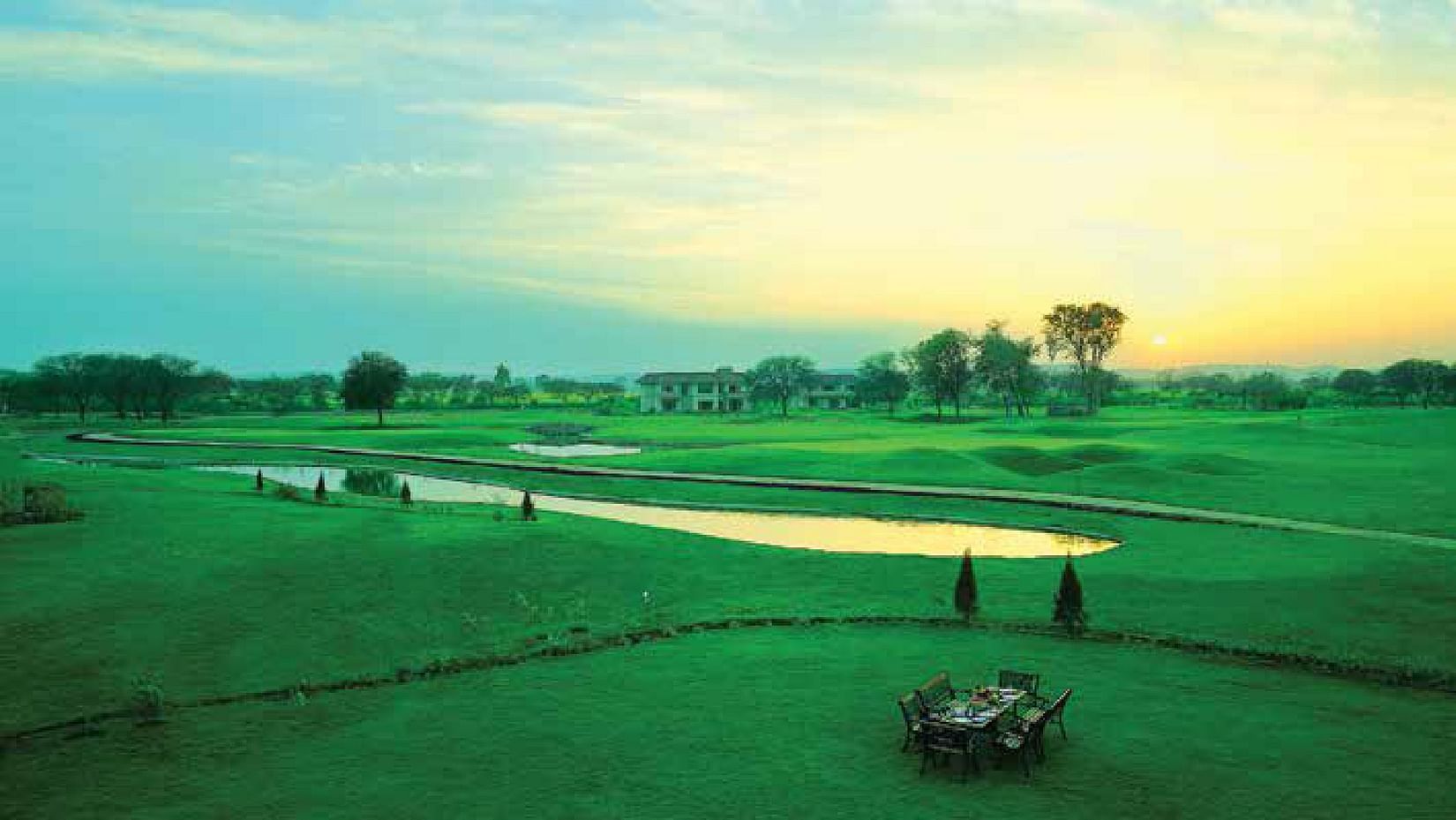 An aerial view of the lawn are with a waterbody in the centre - Karma Lakelands.