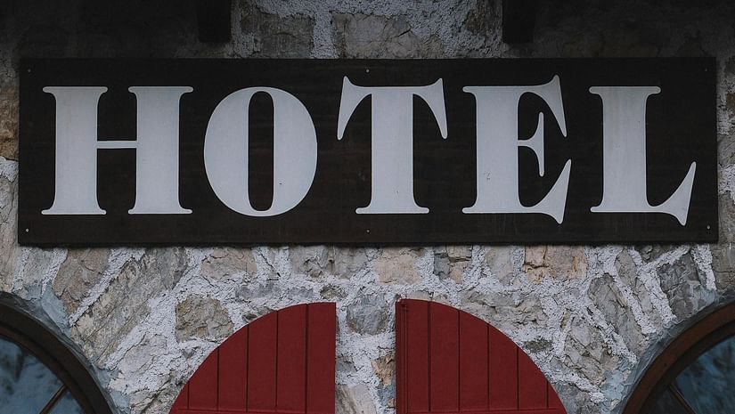 A hotel board with closed windows below.