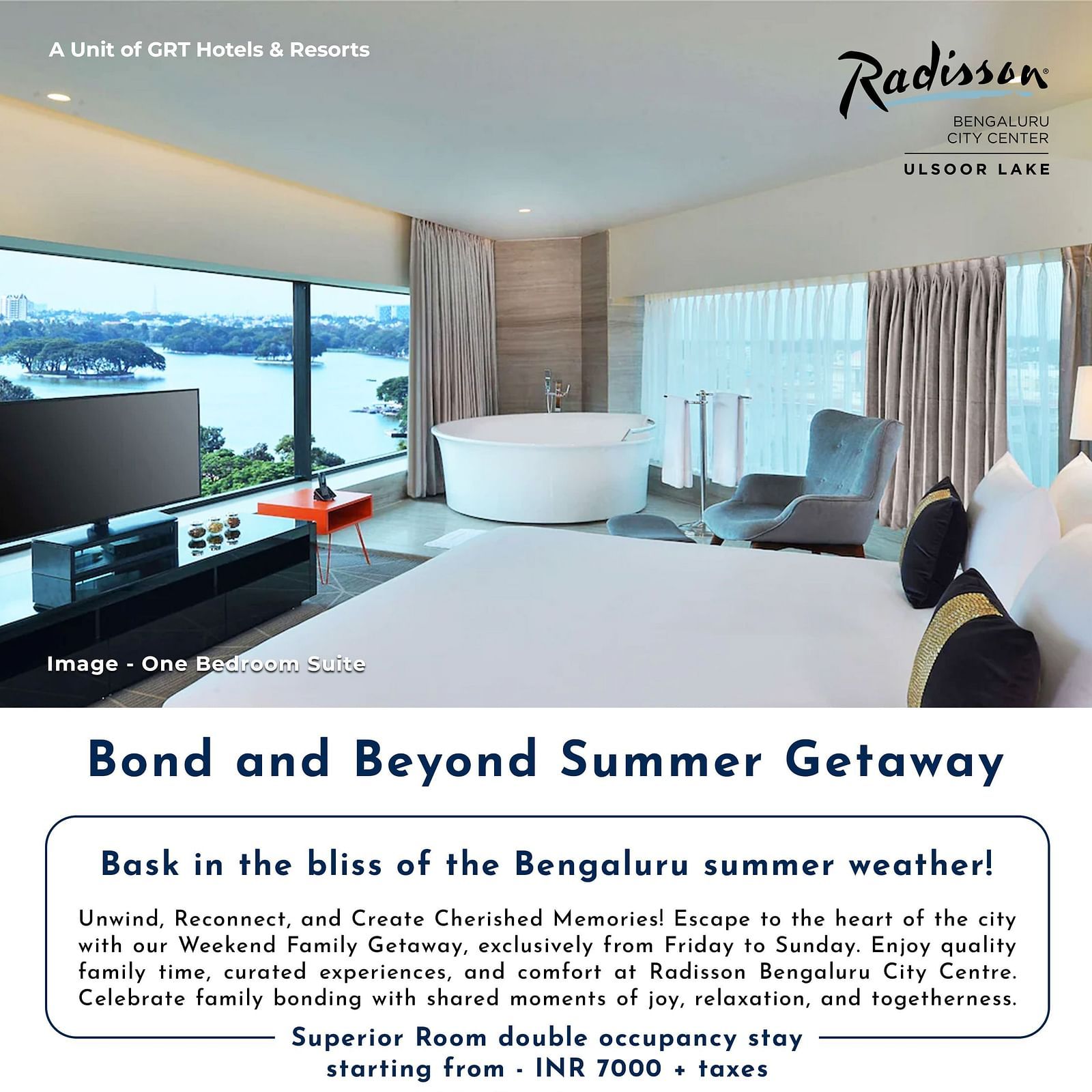 Modern lake-view suite at Radisson Bengaluru City Center featuring a plush bed, TV, and freestanding bathtub – part of the Bond and Beyond Summer Getaway offer.