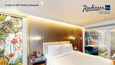  Elegant room with artistic decor, king-size bed, and luxury amenities at Radisson Blu GRT Chennai – promoting the Weekend Staycation package.