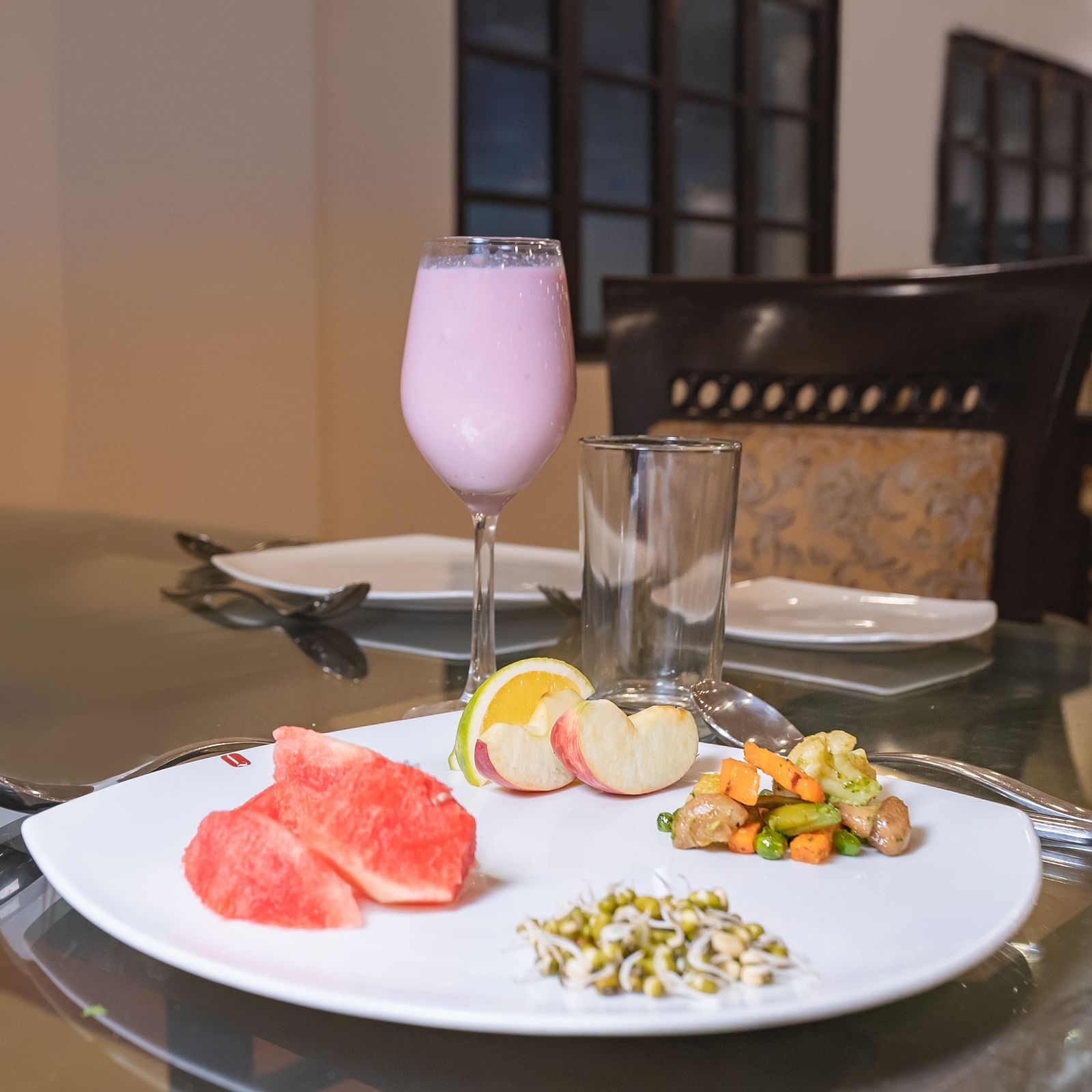 A beautifully plated food served with a juice at Manorath Restaurant at Shri Vallabh Vilas Lords Plaza Nathdwara.