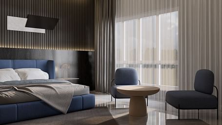 A stylish hotel room with a plush blue bed, modern decor, seating area, and floor-to-ceiling curtains at Town Square Suites.