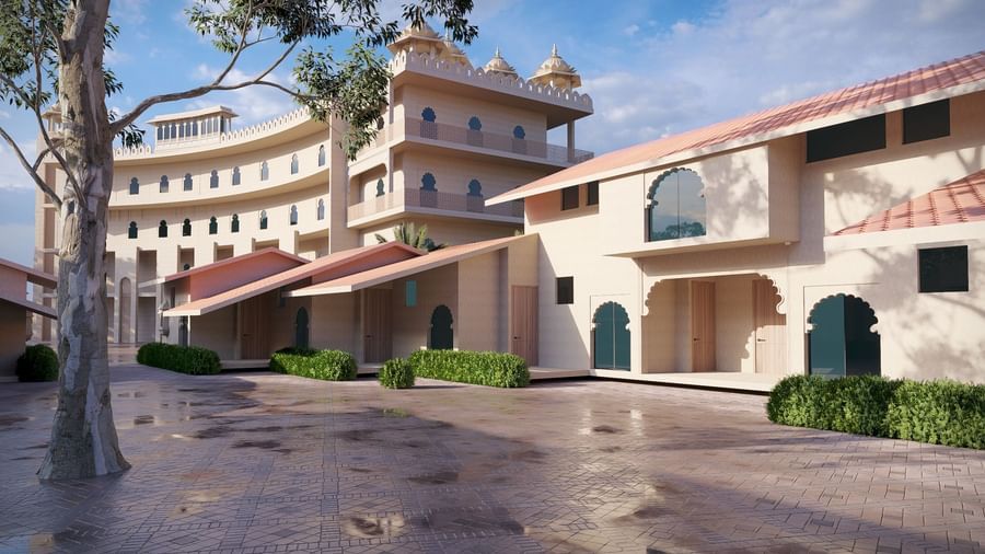 Exterior view of a Bamboo Saa Sunrrise Wedding & Wellness Resort, Jaipur, with a large, wet courtyard.