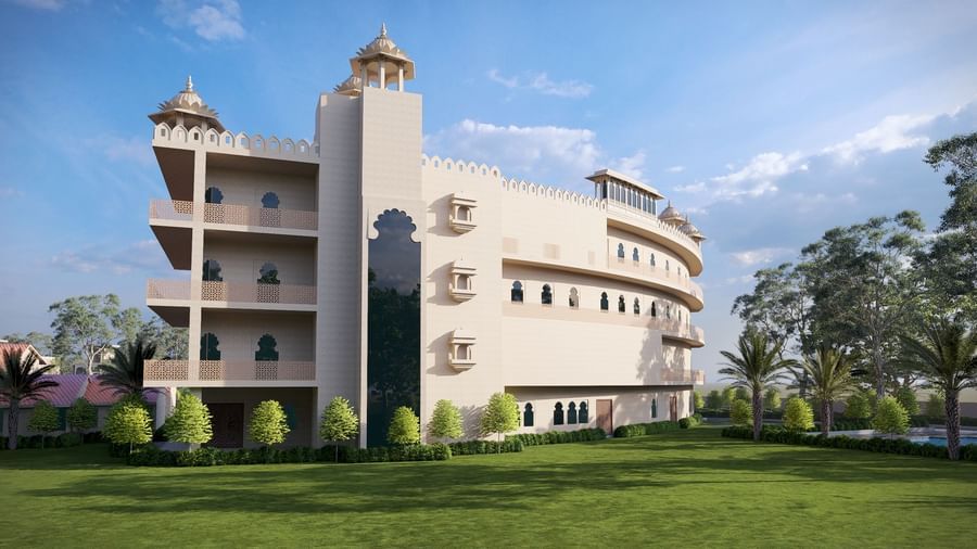 Bamboo Saa Sunrrise Wedding & Wellness Resort, Jaipur building with turrets, surrounded by a lawn and trees.