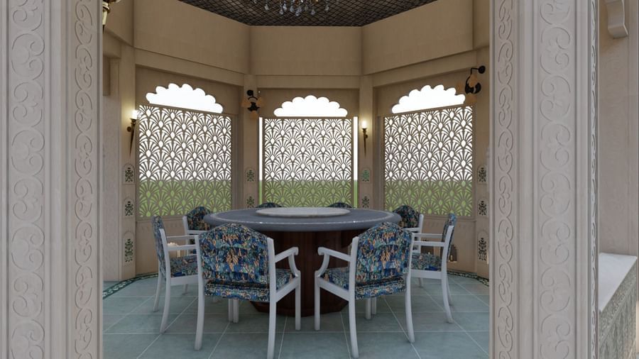 Panch Mahal's dining setup featuring a circular dining table with mosaic patterns, upholstered chairs, ornamental lattice screens, and chandeliers lit by oil lamps - Kaldan Samudhra Palace