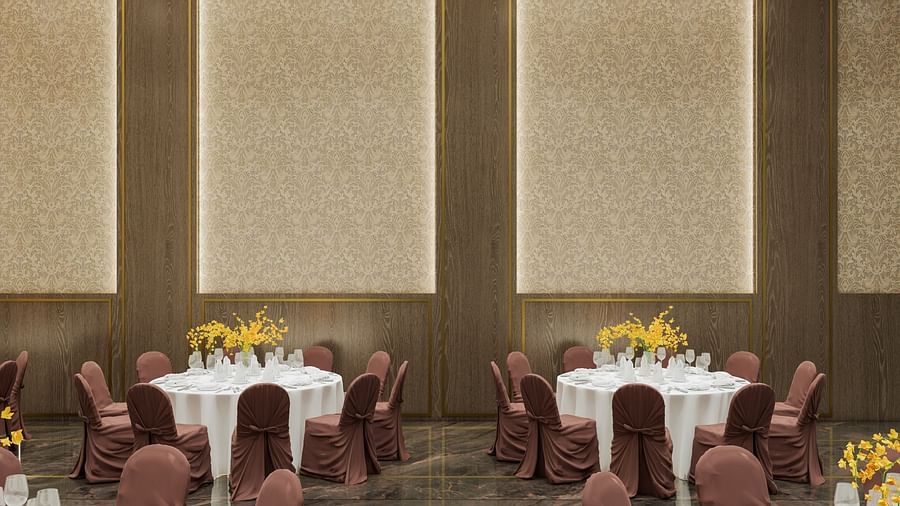 A meeting area with two round tables, chairs, and soft lighting at Town Square Suites.