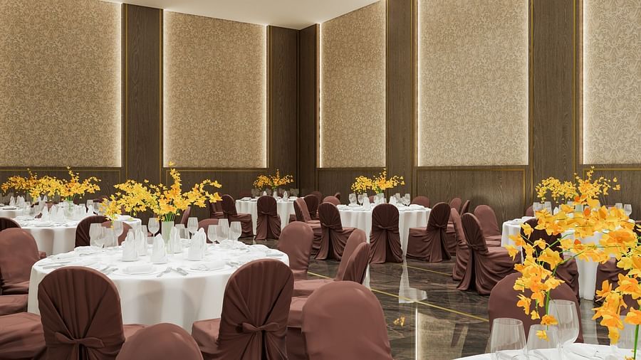 A meeting area with round tables, gold-accented walls, and soft lighting at Town Square Suites.