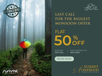Colourful umbrella in misty forest promoting Summit Hotels’ Monsoon Offer – Flat 50% Off. Last call to book and save big on stays this season.