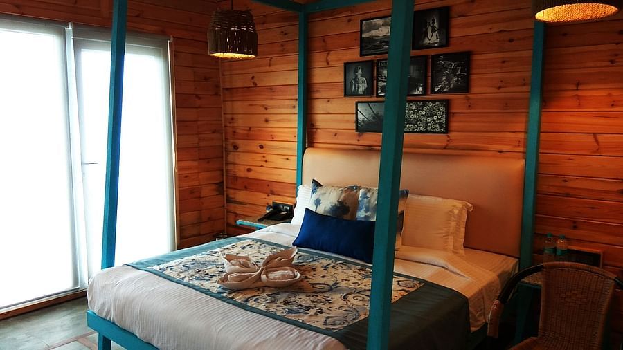 a bed with green pillows and a window beside it