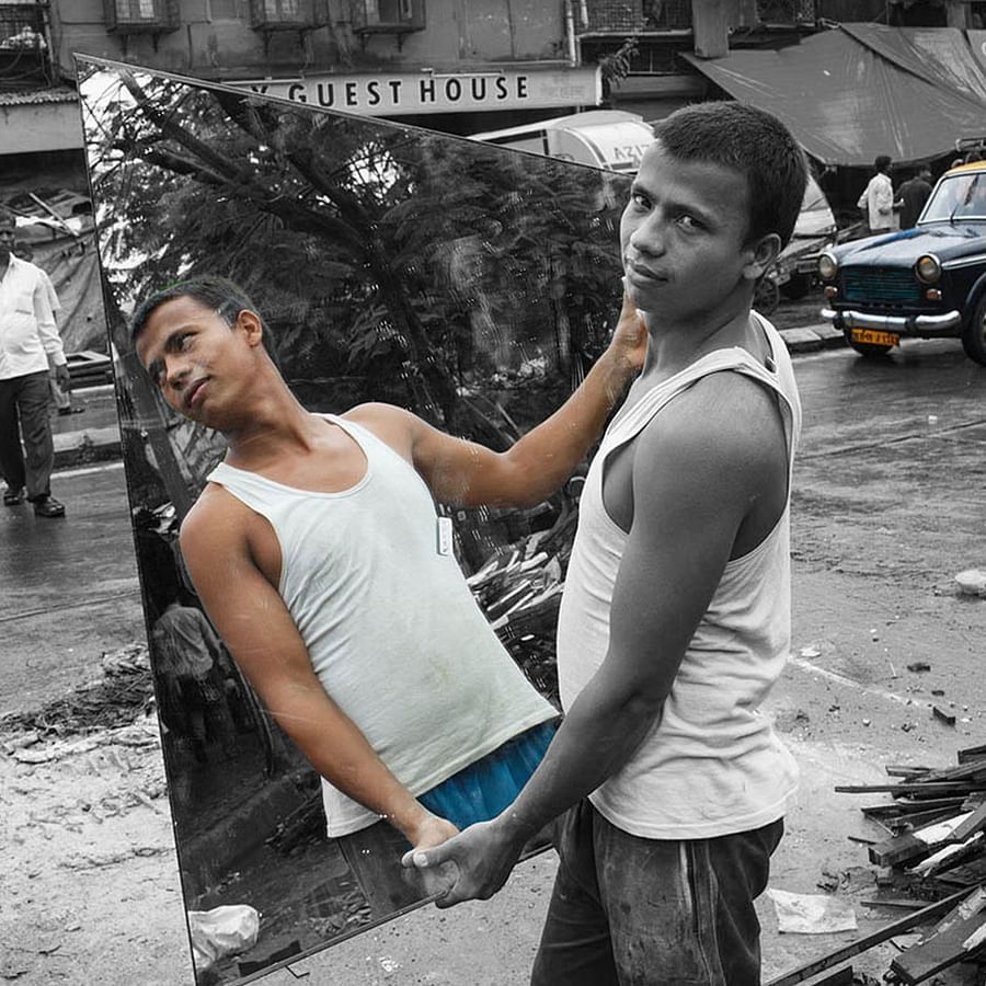 man carrying a mirror