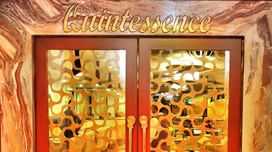 the door to the entrance of Quintessence Restaurant in Chennai - Hotel Raj Park, chennai