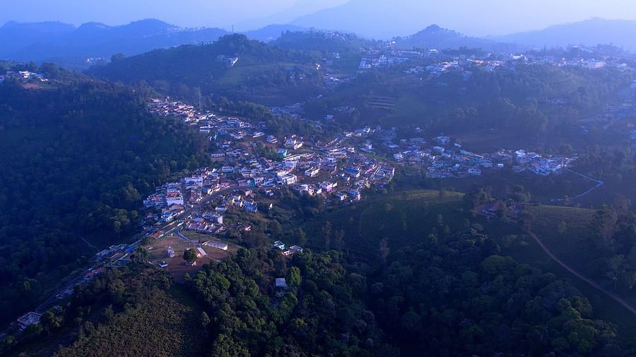 Aerial view of a small town nestled in the hills during twilight.
