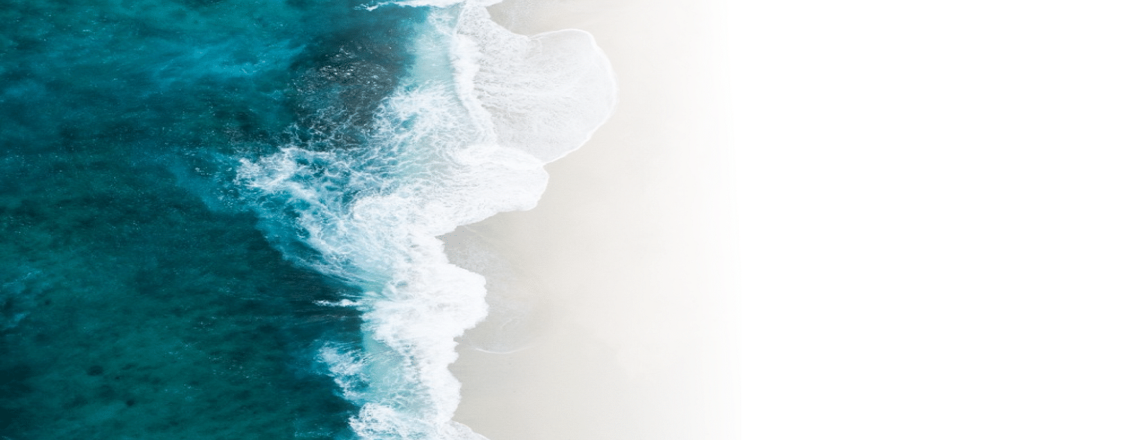 sea water near the beach overlapping on the sand with white foam near the sands