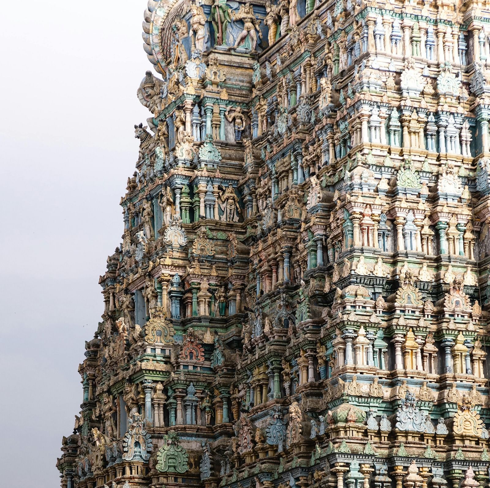 A towering gopuram intricately carved and painted, showcasing Dravidian architecture.