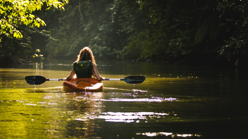 a person kayaking in a lake