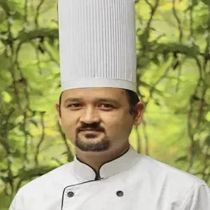 Portrait image of Raju Rokaya, an employee at RD's Nature Retreat, Bengaluru
