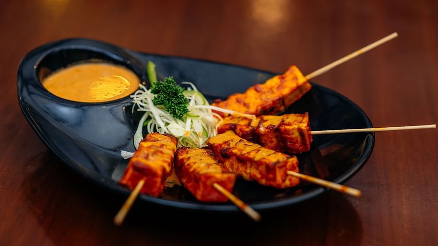 Paneer Tikka served on a black plate with salad at a Lonavala restaurant and bar - Rhythm Lonavala