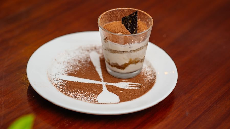 Tiramisu rests on the wooden table - Rhythm Lonavala