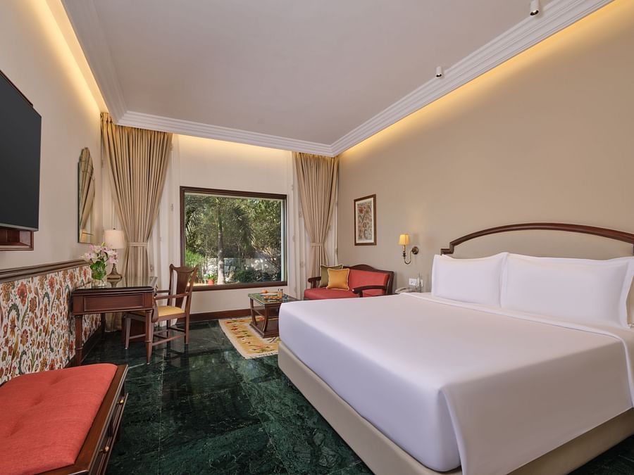 The Premium King Garden View Room at The Ummed Ahmedabad offers a spacious interior with warm lighting and a cozy king size bed