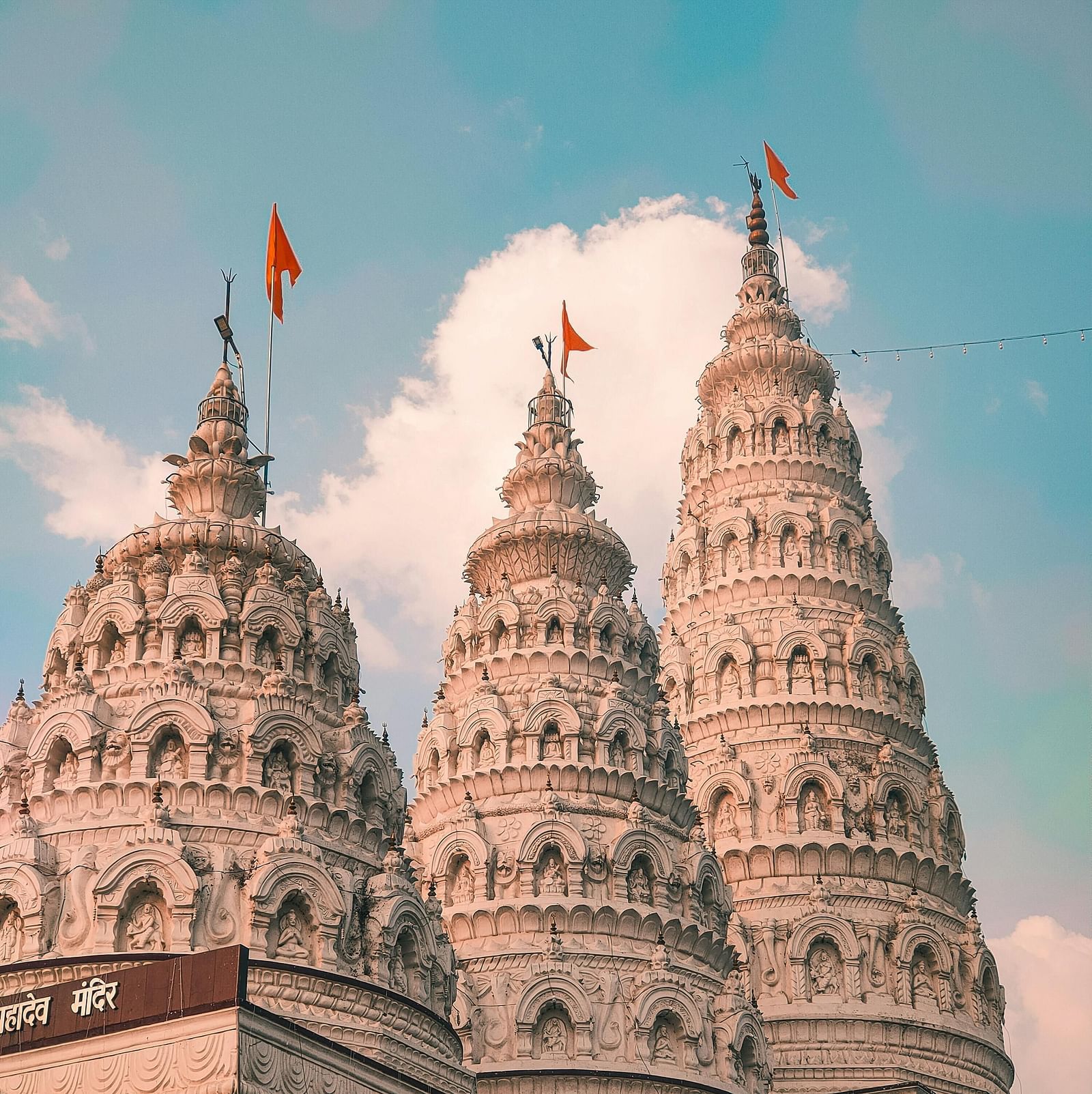 Three intricately designed temple towers rising into the sky