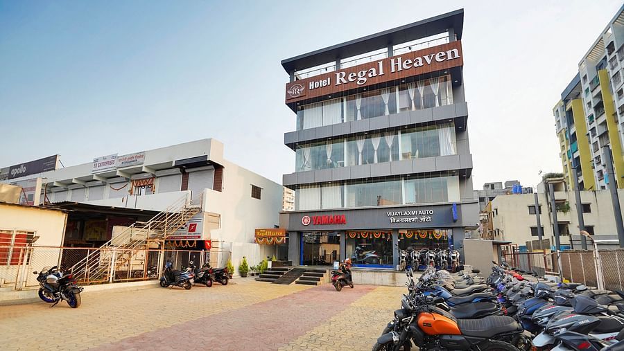 Facade of Hotel Regal Heaven, Pune with parking area in the front.