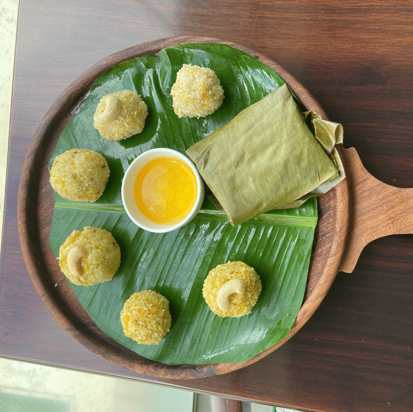 Platter of cheenikaayi kadabu ona banana leaf with a dipping sauce 