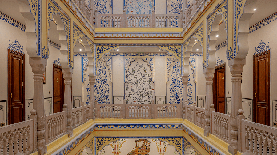 beautifully decorated walls with intricate floral patters and and rajasthani style decor in the first floor - Brij Castle, Jaipur