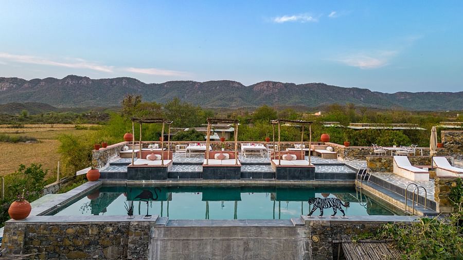 An image of a seating arrangement near the swimming pool in the open - Utsav Camp Sariska
