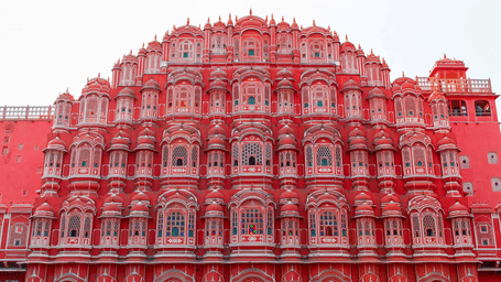 A facade view of Hawa Mahal with its iconic windows and pink coloured walls. A stay at one of the hotels in Jaipur needs to be strategically placed near tourist spots like Hawa Mahal.