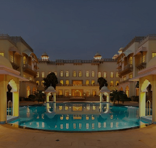 A facade image of a resort with a swimming pool which has a minimal decoration