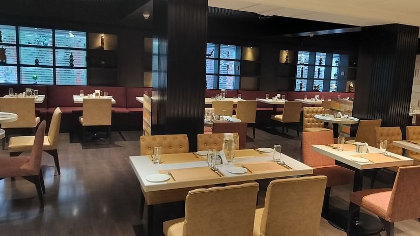 Contemporary restaurant with arranged dining tables and upholstered chairs in a well-lit space
