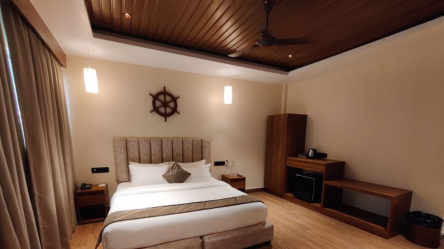 Side view of the room showcasing the veranda with sliding glass doors and greenery