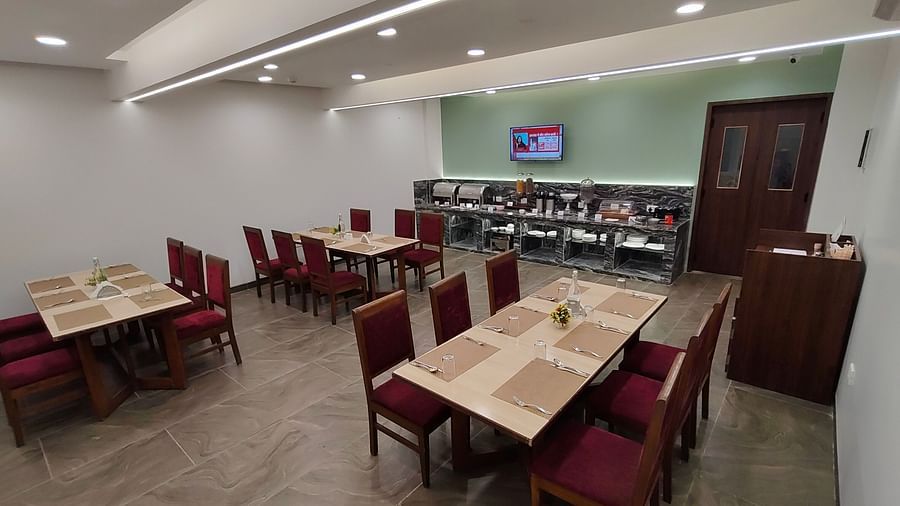 Restaurant-style dining area with red chairs and wooden tables