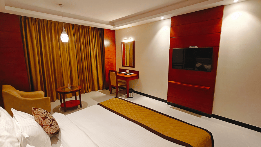 A room with a large bed, sheets, pillows, and curtains. | MM Legacy, Kanchipuram