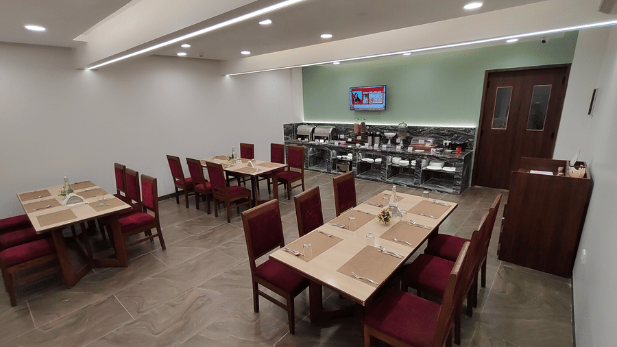 Restaurant-style dining area with red chairs and wooden tables