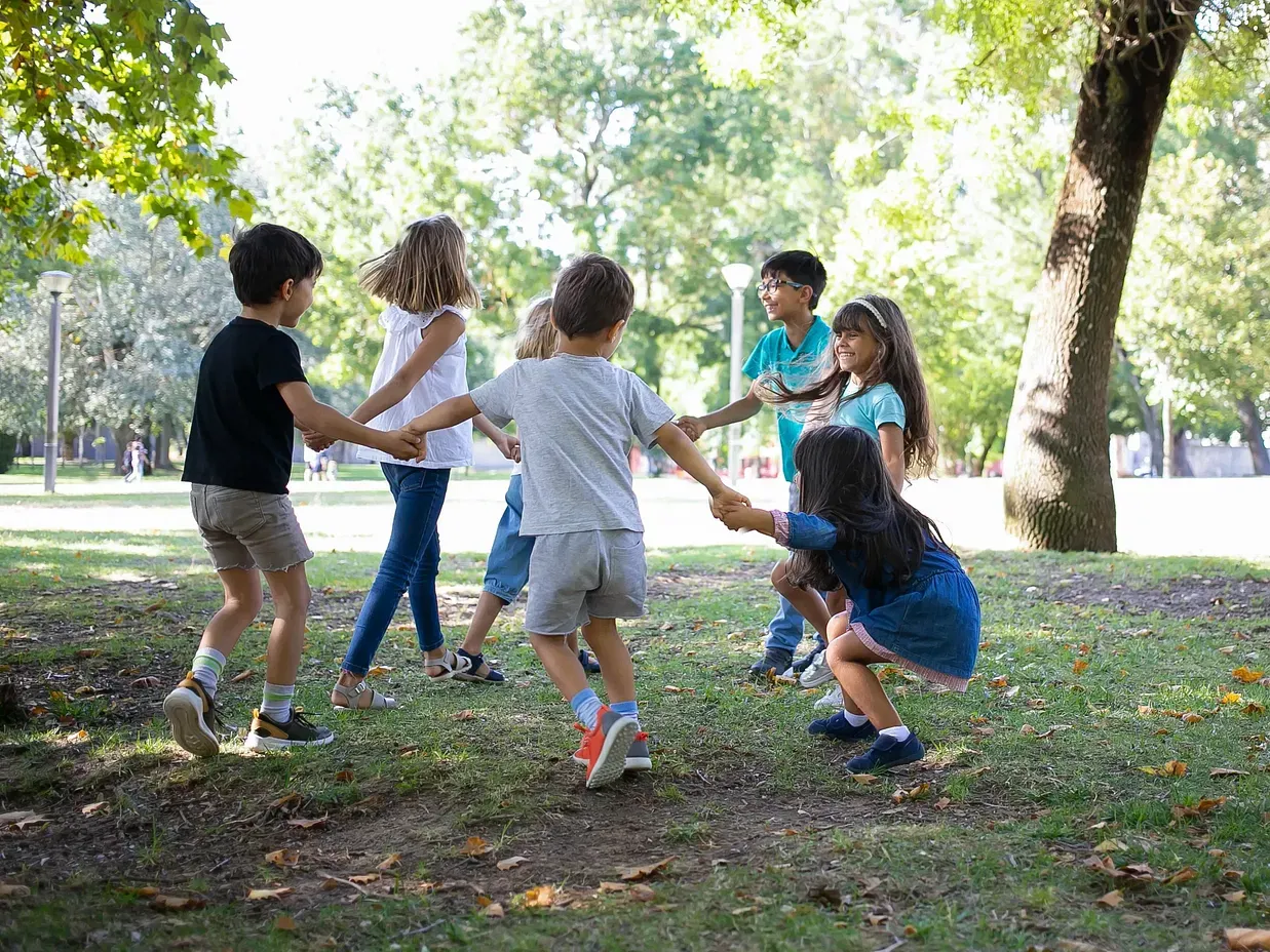 An image of children playing in an open ground that has grass and trees around - Destiny - The Farm Resort, Ooty