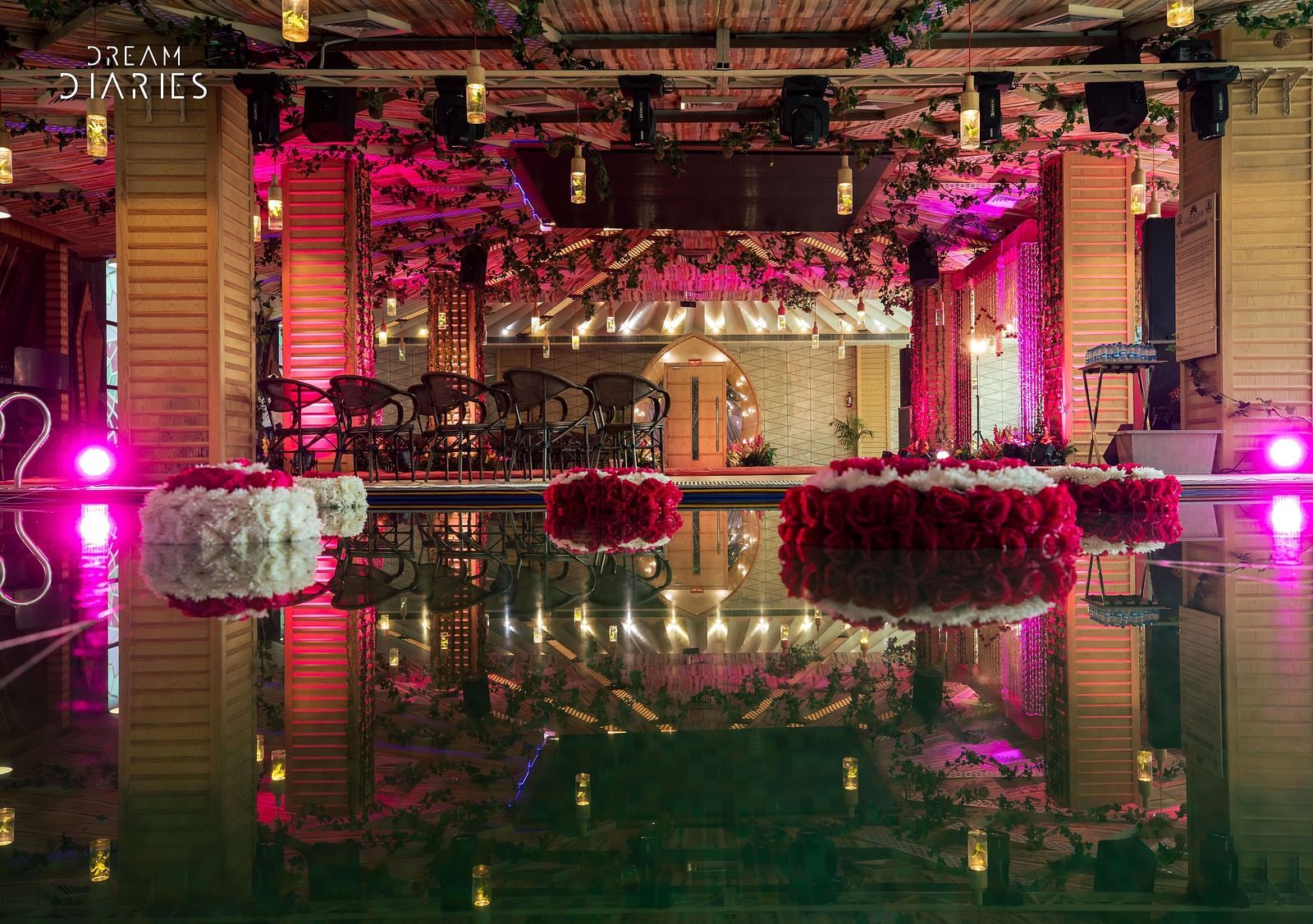 A well decorated banquet hall with seating arrangements and a dance floor - Golden Blossom Imperial resorts Lucknow