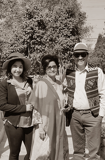 Group of three people posing for a photo outdoors at Karma Chalets.