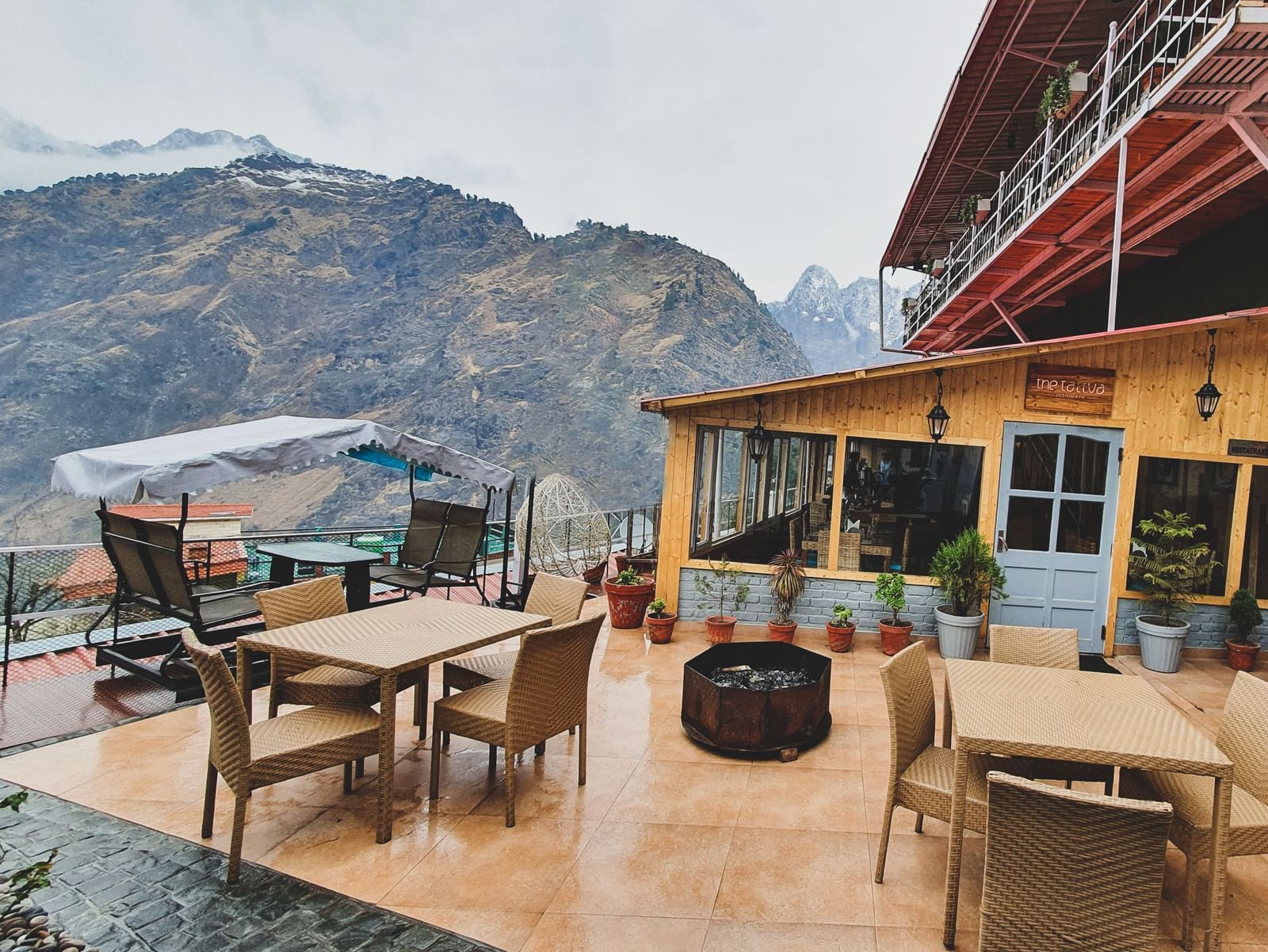 image featuring an open seating area with beautiful mountain views in the background - The Tattva, Joshimath