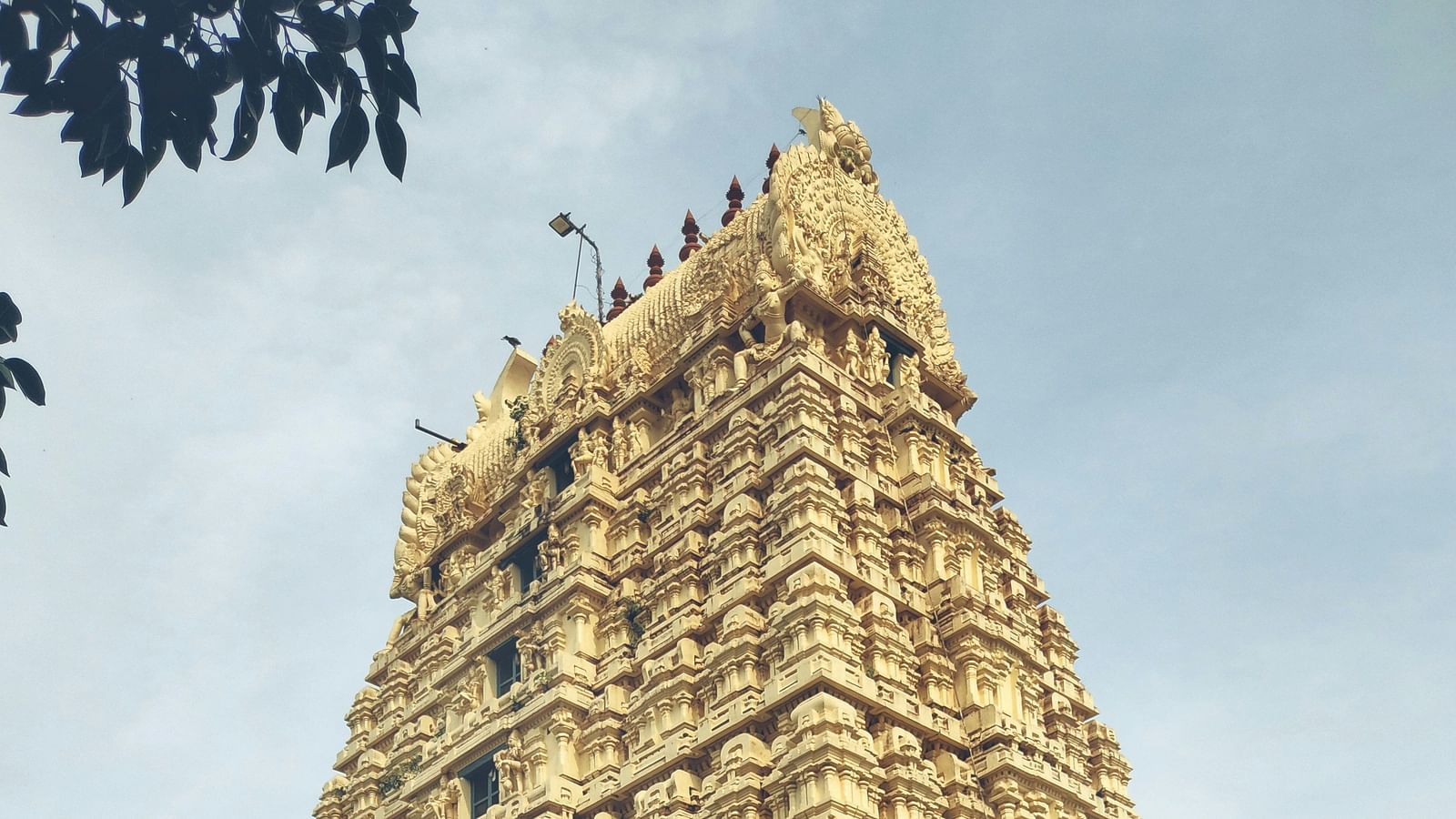 Towering gopuram of a South Indian temple with detailed carvings.