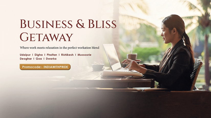A woman dressed in business attire working on her laptop.
