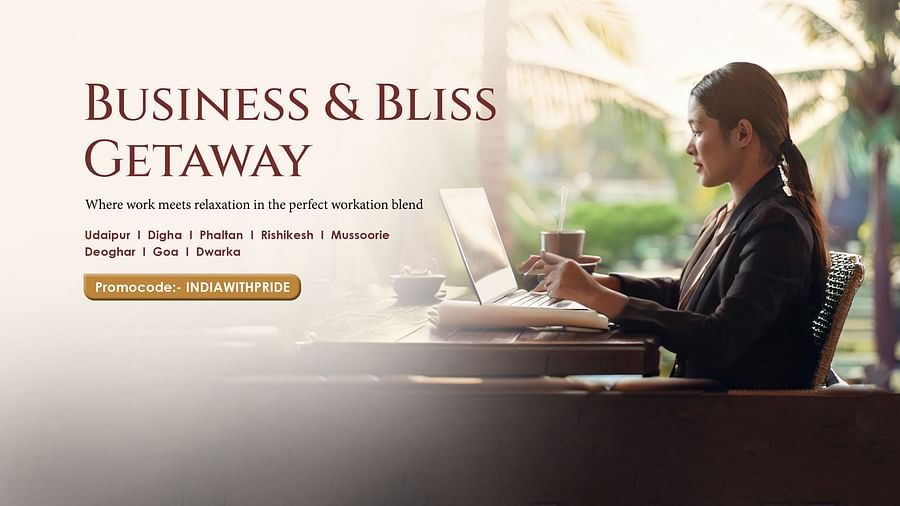 A woman dressed in business attire working on her laptop.