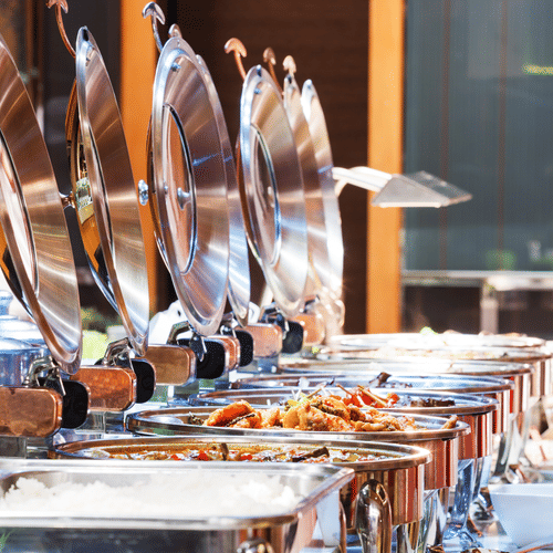 A close up shot of many items kept on trays during a Buffet - La Maison Hotel, Doha