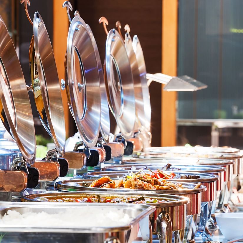 A close up shot of many items kept on trays during a Buffet - La Maison Hotel, Doha