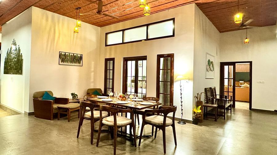Spacious villa dining and living area with warm lighting - BluSalzz Collection - Tranquil Resort, Wayanad