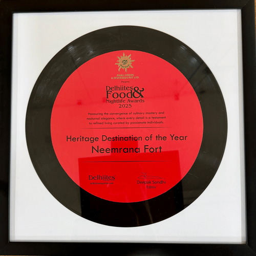 Framed award plaque for 'Heritage Destination of the Year 2025' awarded to Neemrana Fort by Delhiites Food & Nightlife Awards.